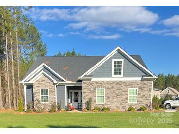 Charming single-story home with stone and gray siding, complemented by a well-maintained lawn at 1030 Stonegate Dr, Salisbury, NC 28147