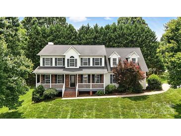 Charming two-story home with a brick-accented porch, black shutters, and lush green lawn at 2367 24Th Street Ne Ln, Hickory, NC 28601
