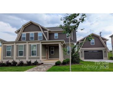 Charming two-story home featuring a covered front porch and attached two-car garage, all beautifully landscaped at 259 Luray Way # 443, Rock Hill, SC 29730