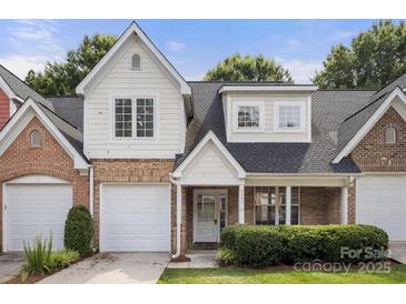 Charming townhome with a well-manicured lawn, brick accents, and attached garage at 4442 Coventry Row Ct, Charlotte, NC 28270
