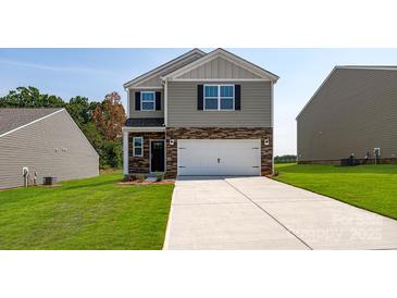 Charming two-story home with stone accents, a two-car garage, and a well-maintained lawn at 4685 Mammoth Rd, Hickory, NC 28602