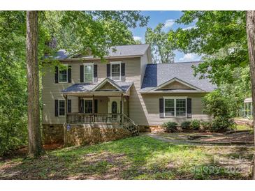 Charming two-story home with stone accents, covered front porch, and mature trees at 500 Mount Pleasant N Rd, Mount Pleasant, NC 28124