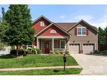 Charming two-story home with a welcoming front porch and well-manicured lawn, inviting curb appeal at 1152 Mckee Farm Ln, Belmont, NC 28012