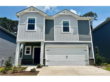 Two-story home featuring gray and white siding, a two-car garage, and a well-maintained front yard at 1426 31St Ne St, Conover, NC 28613