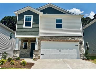 Charming two-story home featuring stone accents, a two-car garage, and a mix of traditional and modern design elements at 1458 31St Ne St, Conover, NC 28613