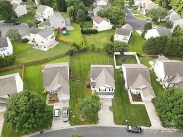 Expansive aerial view of neighborhood homes with manicured lawns and mature trees, showcasing the residential area at 2527 Fossil Stone Ln, Fort Mill, SC 29708