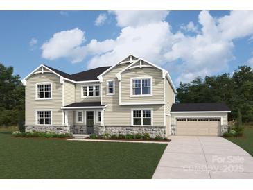 Charming two-story home with a well-manicured lawn and a three-car garage at 2541 Mabel Ln, Monroe, NC 28110