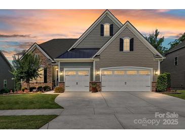 Charming home with a two-car garage, stone accents and manicured lawn at 2972 Arches Bluff Cir, Lancaster, SC 29720