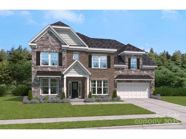 Charming two-story home with a mix of stone and brick, accented by dark shutters and a well-manicured lawn at 324 Coronado Ave, Matthews, NC 28104