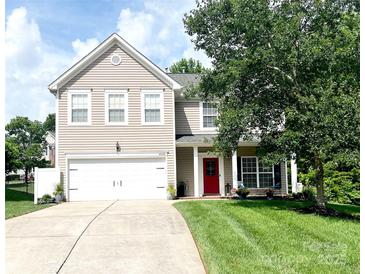 Charming two-story home featuring a red front door, well-manicured lawn, and a two-car garage at 4048 Cascade Dr, Gastonia, NC 28056