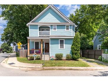 Charming two-story home featuring a covered porch and upper balcony, freshly painted in light blue at 501 Mercury St, Charlotte, NC 28205