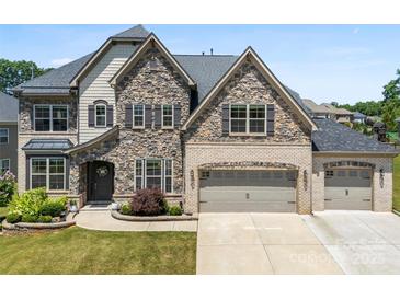 Beautiful two-story home with a stone and brick facade and a spacious three-car garage at 837 Kathy Dianne Dr, Indian Land, SC 29707