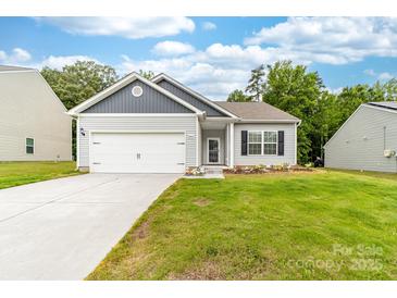 Charming single-story home with a well-manicured lawn, a two-car garage, and beautiful landscaping at 8416 Highgate Dr, Charlotte, NC 28215