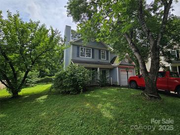 Charming two-story home with well-manicured lawn and mature trees in a quiet neighborhood at 8904 Daventry Pl, Charlotte, NC 28215
