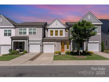 Charming townhomes with attached garages and manicured lawns create an inviting curb appeal at 9221 Widden Way, Charlotte, NC 28269
