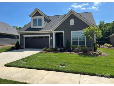 Charming home featuring manicured lawn, attached garage, and Craftsman-style detailing for a welcoming curb appeal at 1330 Millview Ln, Matthews, NC 28104