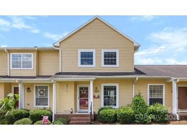 Charming yellow two-story home with well-maintained landscaping and a welcoming front porch at 1670 Robins Nest Ct # C, Gastonia, NC 28054