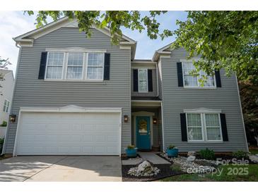 Charming two-story home with a bright teal front door, black shutters, and attached garage at 2090 Durand Rd, Fort Mill, SC 29715