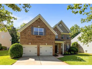 Charming brick home with a two-car garage, well-manicured lawn, and lovely landscaping at 3006 S Legacy Park Blvd, Indian Land, SC 29707
