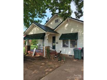 Charming single-story home with a welcoming front porch and awnings at 3220 Harmony Hwy, Harmony, NC 28634