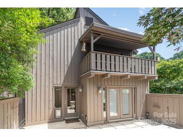 Side exterior of the property showcasing a balcony, a small patio, and doors leading inside the house at 4725 Rounding Run Rd, Charlotte, NC 28277