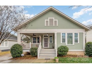 Charming green home with a inviting front porch and well-maintained landscaping at 232 Orange St, Charlotte, NC 28205