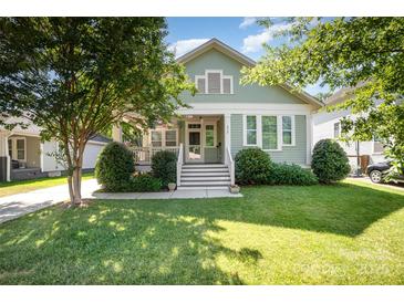Charming home with a well-manicured lawn, lush landscaping, and a welcoming front porch, perfect for relaxation at 232 Orange St, Charlotte, NC 28205