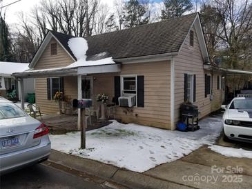 Charming single-Gathering home showcasing a quaint covered porch and a traditional architectural style in a winter setting at 2942 Reid Ave, Charlotte, NC 28208