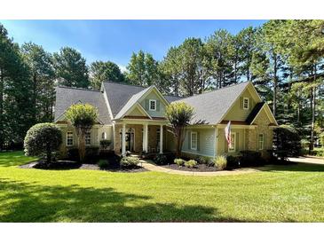 Charming single-Gathering home with manicured lawn, lush landscaping, and inviting covered entryway at 347 Bayberry Creek Cir, Mooresville, NC 28117