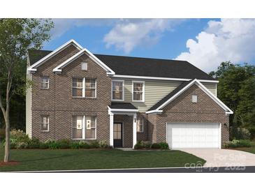 Inviting two-story home with a brick facade, attached garage, manicured lawn, and classic architectural details at 416 Balboa St, Matthews, NC 28104