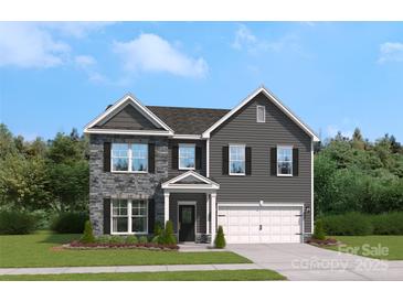 Charming two-story home with stone accents, a two-car garage, and a well-manicured front lawn at 420 Balboa St, Matthews, NC 28104
