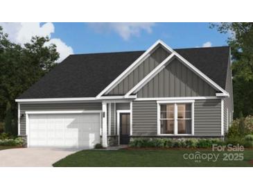Charming single-Gathering home featuring gray siding, a two-car garage, and well-maintained landscaping at 5232 Raging Creek Dr, Indian Trail, NC 28079