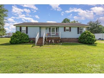 Charming single-story home with a welcoming front porch and landscaped yard, perfect for suburban living at 7785 Crestwood Dr, Kannapolis, NC 28081