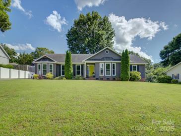 Charming home featuring a well-manicured lawn and a striking yellow front door at 116 Hallett St, Fort Mill, SC 29715