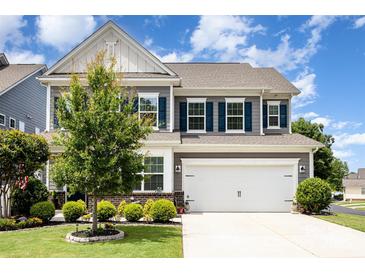Charming two-story home featuring a well-maintained lawn, blue shutters, and an attached two-car garage at 126 W Morehouse Ave, Mooresville, NC 28117