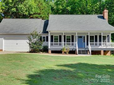 Charming home featuring a cozy front porch, attached garage, and well-maintained lawn at 1529 Covenant Pl, Rock Hill, SC 29732