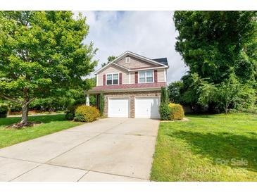 Charming two-story home features a stone facade, two-car garage, and well-manicured landscaping at 405 Jenny Skip Ln, Rock Hill, SC 29732