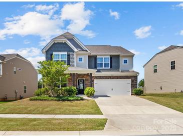 Charming two-story home with a well-manicured lawn and attached two-car garage at 4261 Coachwhip Ave, Lancaster, SC 29720