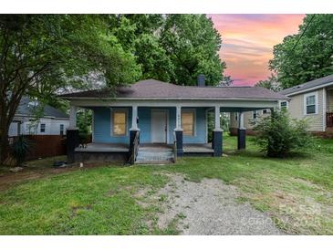 Charming single-story home showcasing a welcoming front porch and a well-maintained lawn at 4510 Wildwood Ave, Charlotte, NC 28208