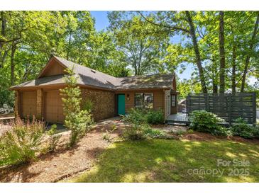 Charming single-story home featuring mature landscaping, a brick facade, and a cozy front porch at 498 Glory Ct, Fort Mill, SC 29715