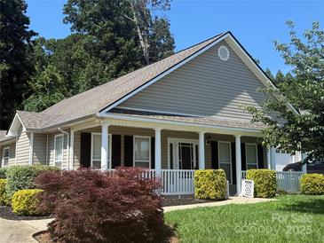 Charming home with a welcoming front porch, white columns, neutral siding, and well-manicured landscaping at 156 Tarrington Dr, Statesville, NC 28625