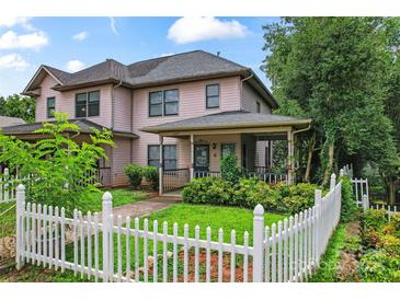 Charming two-story home featuring a white picket fence and a covered front porch at 1609 Begonia Way, Rock Hill, SC 29732
