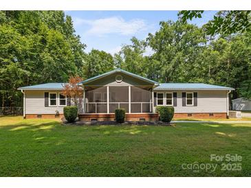 Charming single-story home with a screened-in porch and well-maintained front lawn at 7011 S Providence Rd, Waxhaw, NC 28173