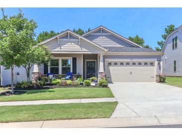 Charming single-Gathering home with a well-manicured lawn, lovely front porch, and attached two-car garage at 9541 Festival Way, Charlotte, NC 28215