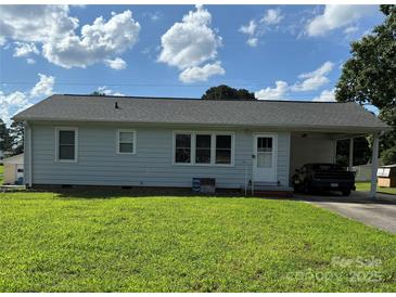 Charming single story home featuring a covered carport and lush front lawn at 1314 Hathcock Ave, Albemarle, NC 28001