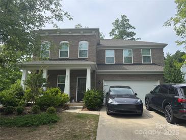 Charming brick two-story home with a welcoming front porch and well-maintained landscaping at 15636 Oleander Dr, Charlotte, NC 28278