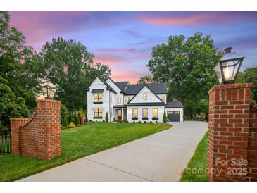 Stunning new construction home with a large front yard and modern design elements at 16112 Terry Ln, Huntersville, NC 28078