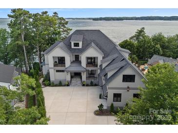 A beautiful, modern two story home with gray trim and a spacious, newly poured concrete driveway at 18007 Harbor Light Blvd, Cornelius, NC 28031