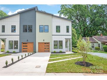 Modern townhome featuring varied siding, complemented by a well-manicured lawn and an attached garage at 2733 Cowles Rd, Charlotte, NC 28208