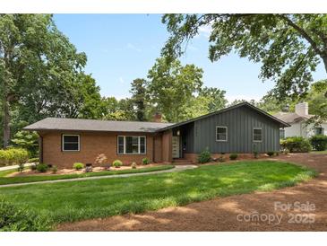 Charming brick home with a well-manicured lawn and mature trees in a serene neighborhood at 3701 Table Rock Rd, Charlotte, NC 28226